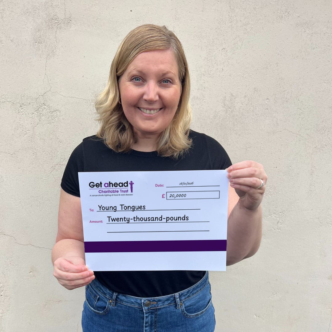 Barbara Fountain, CEO of Norwich-based Young Tongues holds up a £20,000 cheque donated by Get A-Head.