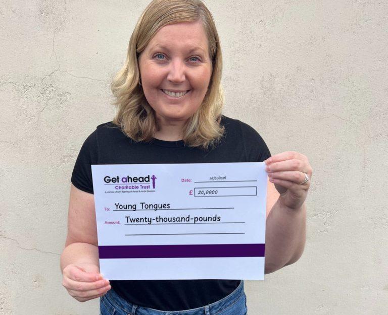 Barbara Fountain, CEO of Norwich-based Young Tongues holds up a £20,000 cheque donated by Get A-Head.